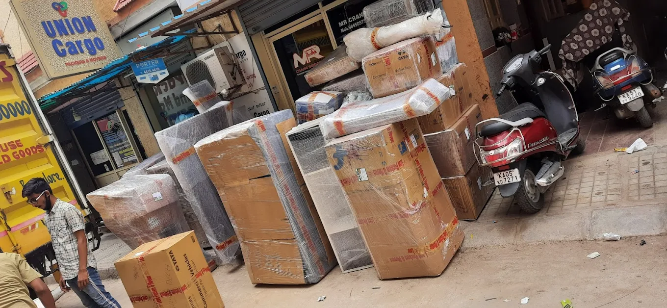 Professional packer at Union Packers and Movers Bangalore wrapping furniture with protective packing material
